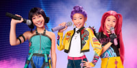 Three girls dressed up in Halloween costumes depicting characters from the girl group in KPop Demon Hunters